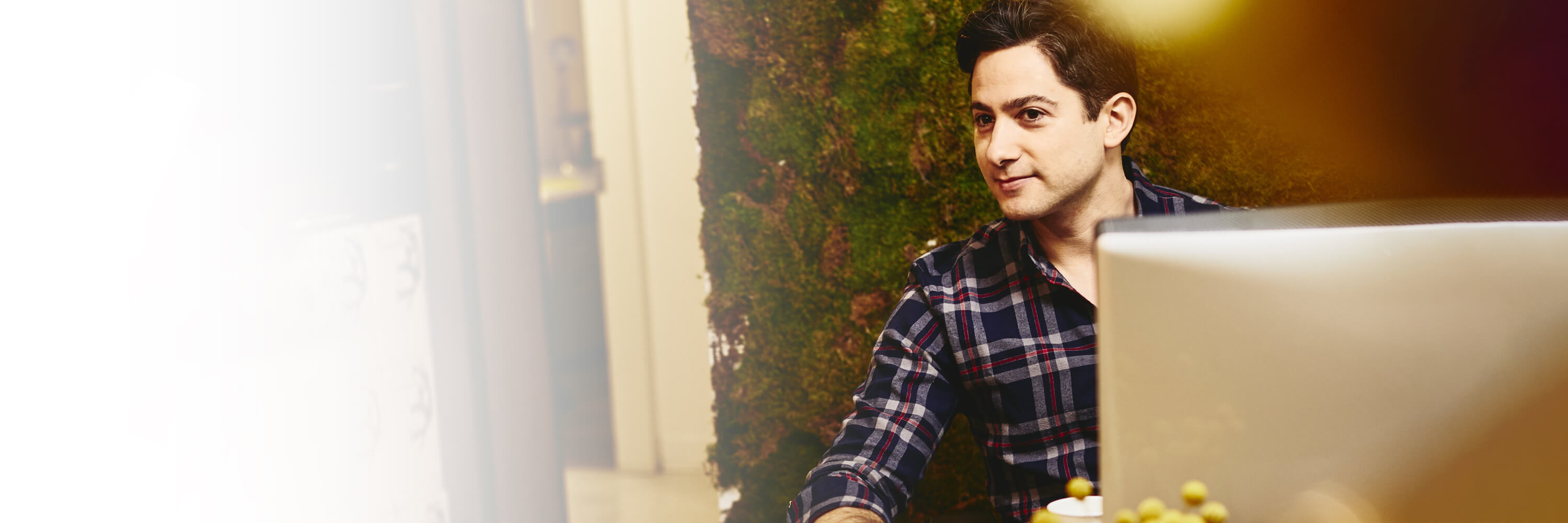 Smiling man sitting behind his desk.