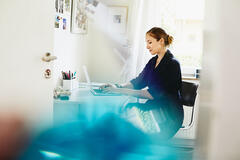 a woman working on her computer