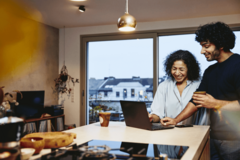 man and woman looking at the same computer