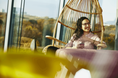 woman siting on a Rotan chair