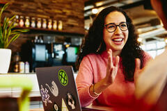 Close up - Smiling woman talking to someone.