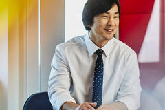 Man wearing a tie working on his computer.