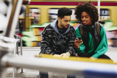 2 young people looking at a cellphone
