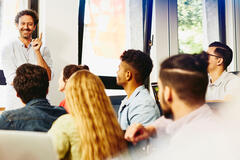 man speaking in front of a group