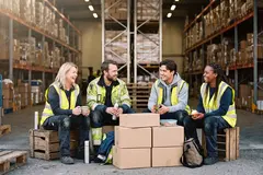 Engineer sitting together in warehouse