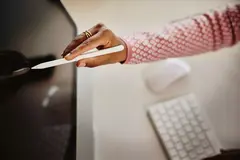 Close up of touch pen touching a desktop screen