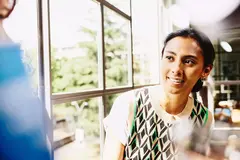 Smiling female looking at someone.
