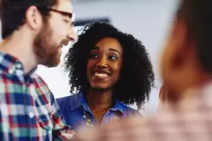Group of colleagues talking and laughing. 