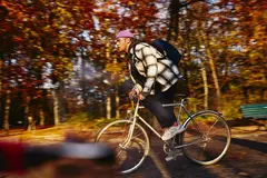 Cycling male, autumn trees on the background.
