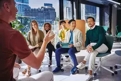 Group of people having a meeting, in a room with glass windows