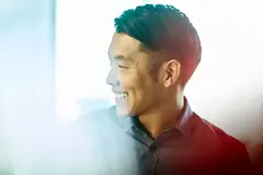 Close up - Smiling male looking away.
