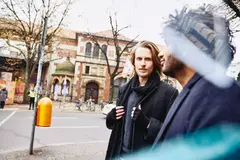 Two men walking on the streets.
