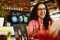 Close up - Smiling woman talking to someone.