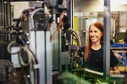 Woman operating a machine on a production site.