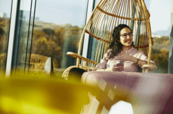 woman siting on a Rotan chair
