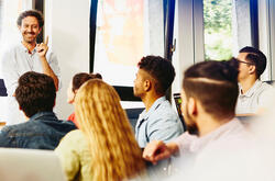 man speaking in front of a group