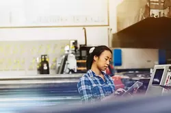 Womale operating a touch-screen display. 
