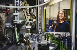 Woman operating a machine on a production site. 