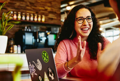 Close up - Smiling woman talking to someone.