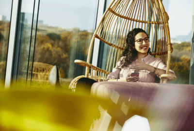 woman siting on a Rotan chair