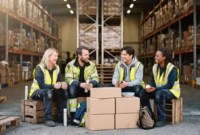 Engineer sitting together in warehouse