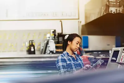 Womale operating a touch-screen display. 
