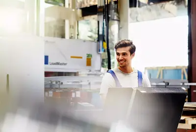 Smiling male on a production site
