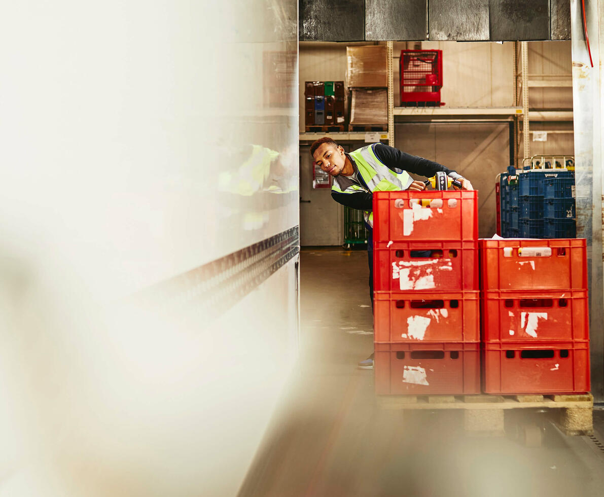 Man unloading crates from truck