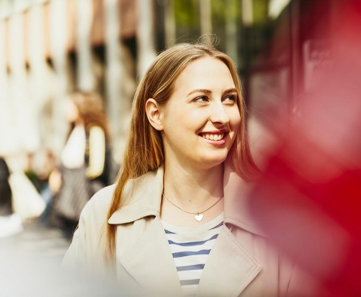 Close up - Student (woman) smiling looking away.