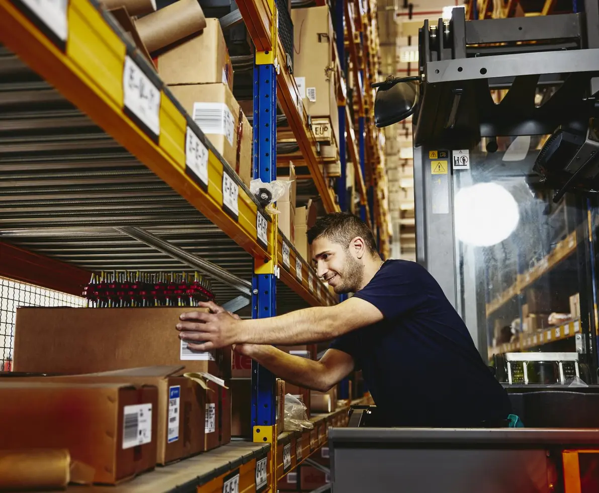 man working at a packing station