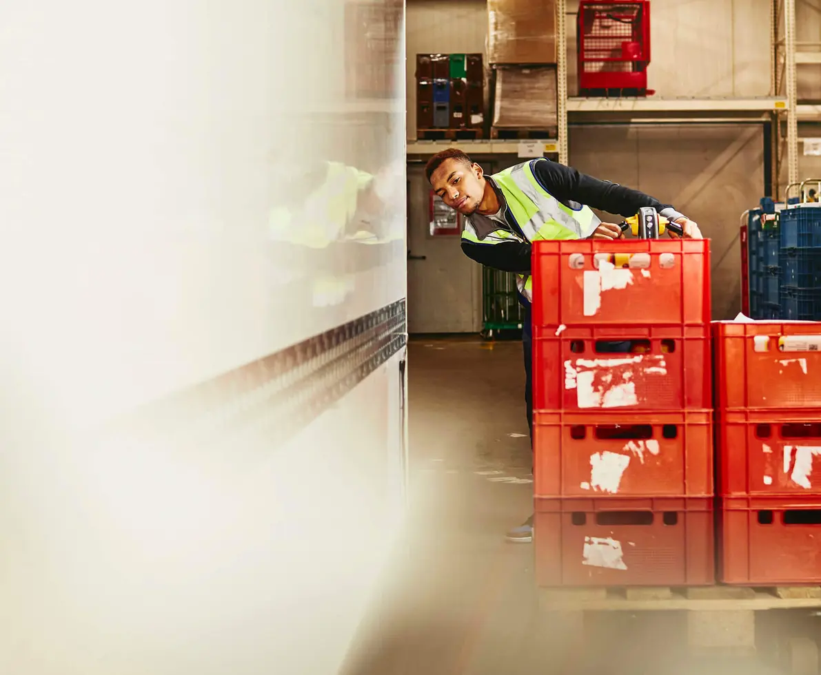 Man unloading crates from truck