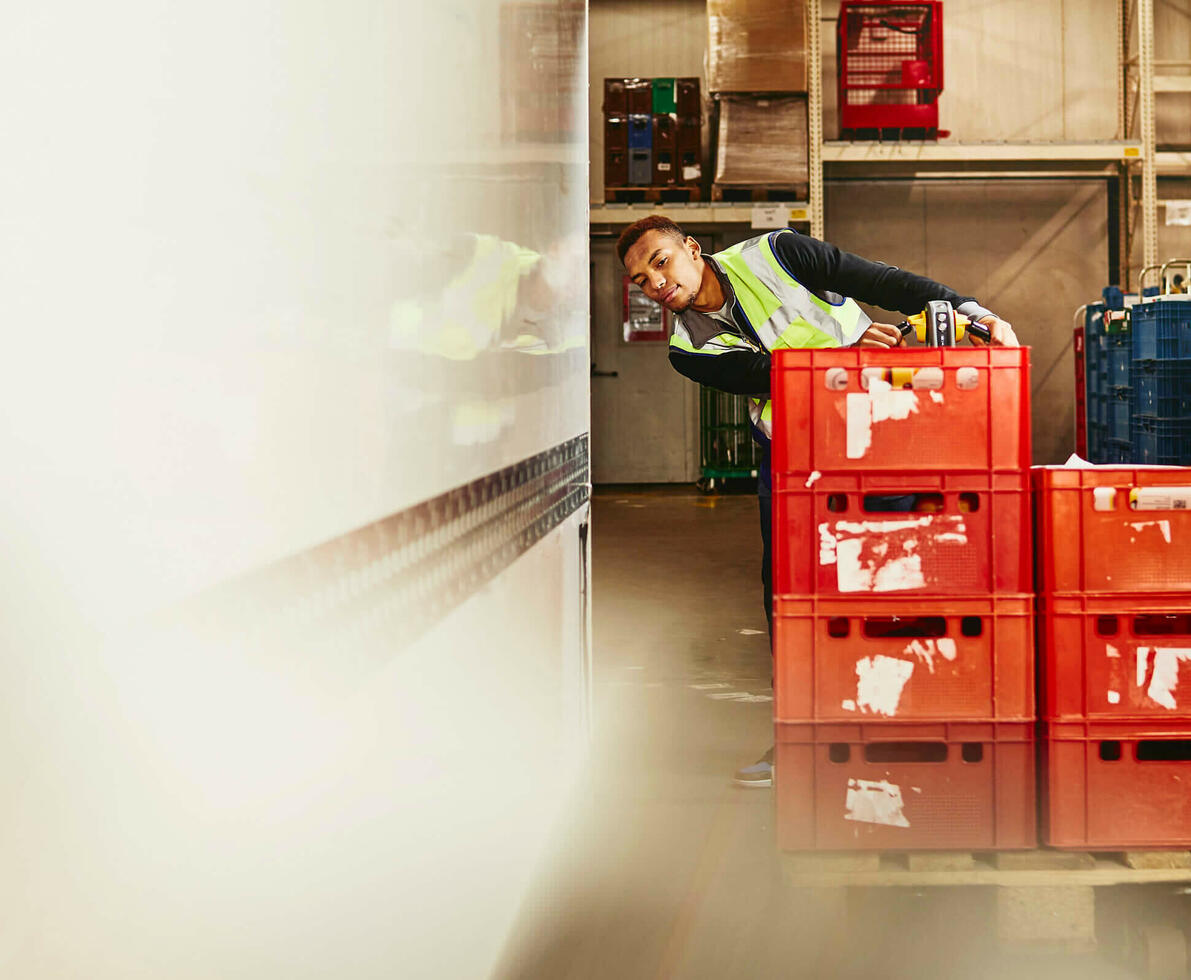 Man unloading crates from truck