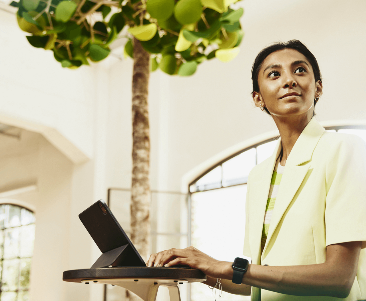 woman looking away in front of laptop