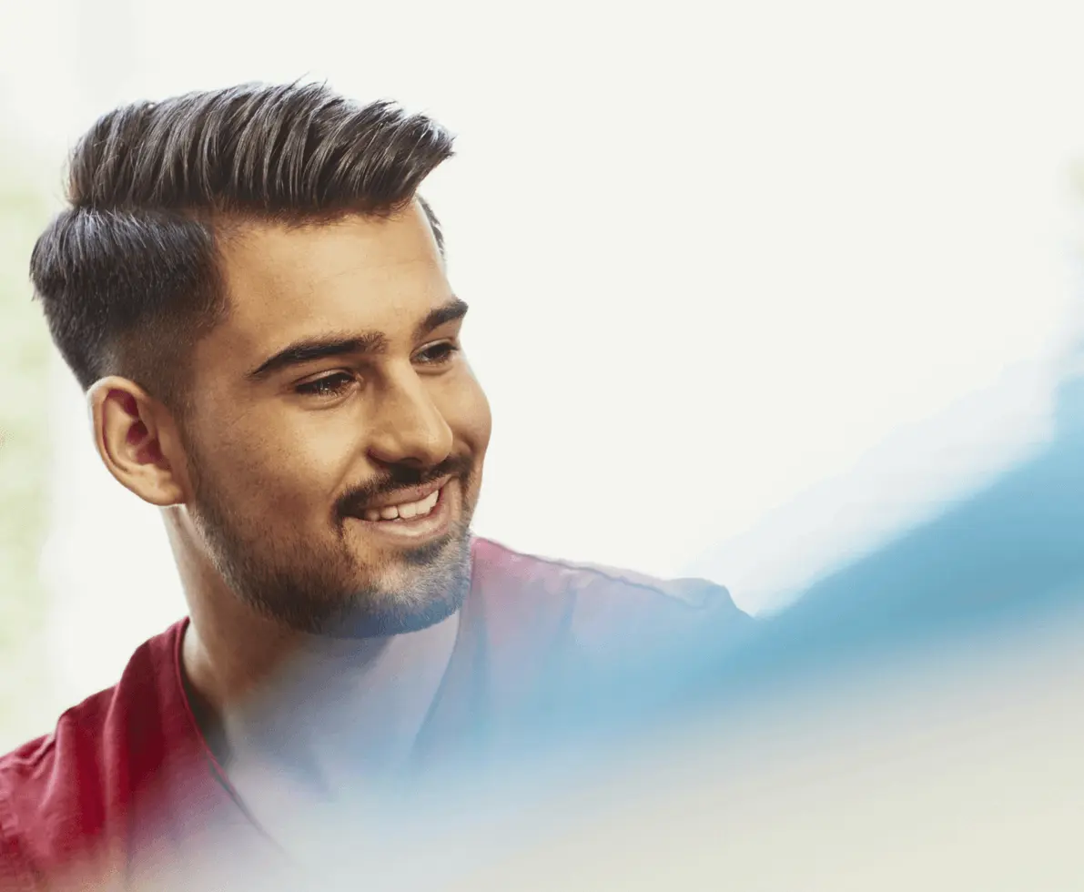man looking to the side smiling