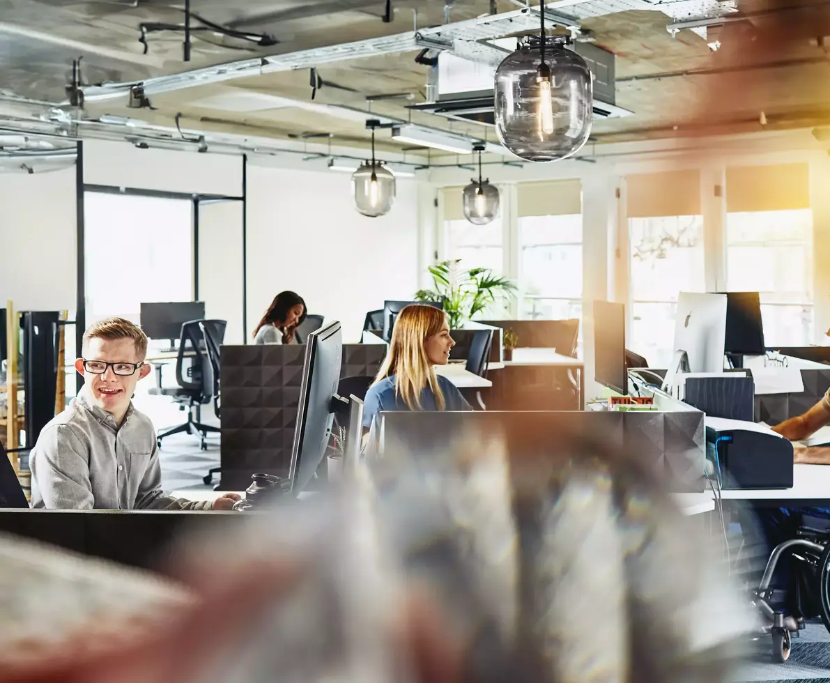 Group of people working behind their computers at their cubicles at the office. Focused.