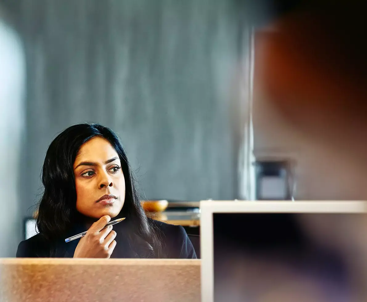 Womale watching over her desk. 
