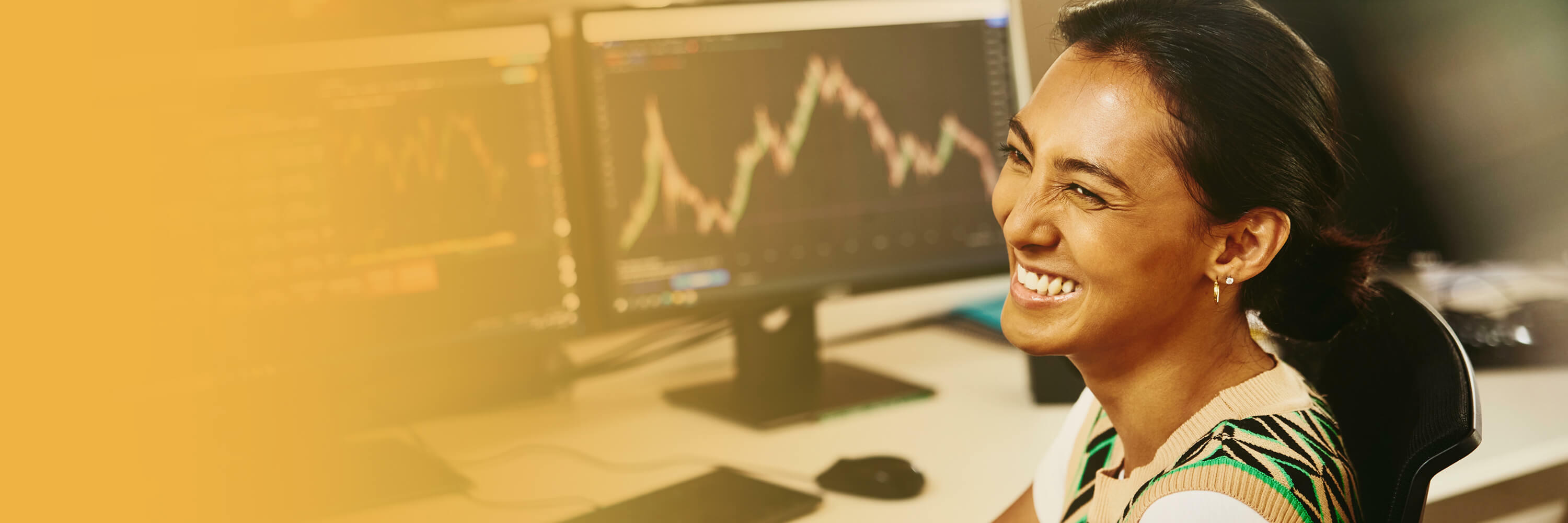 woman in front of computer smiling