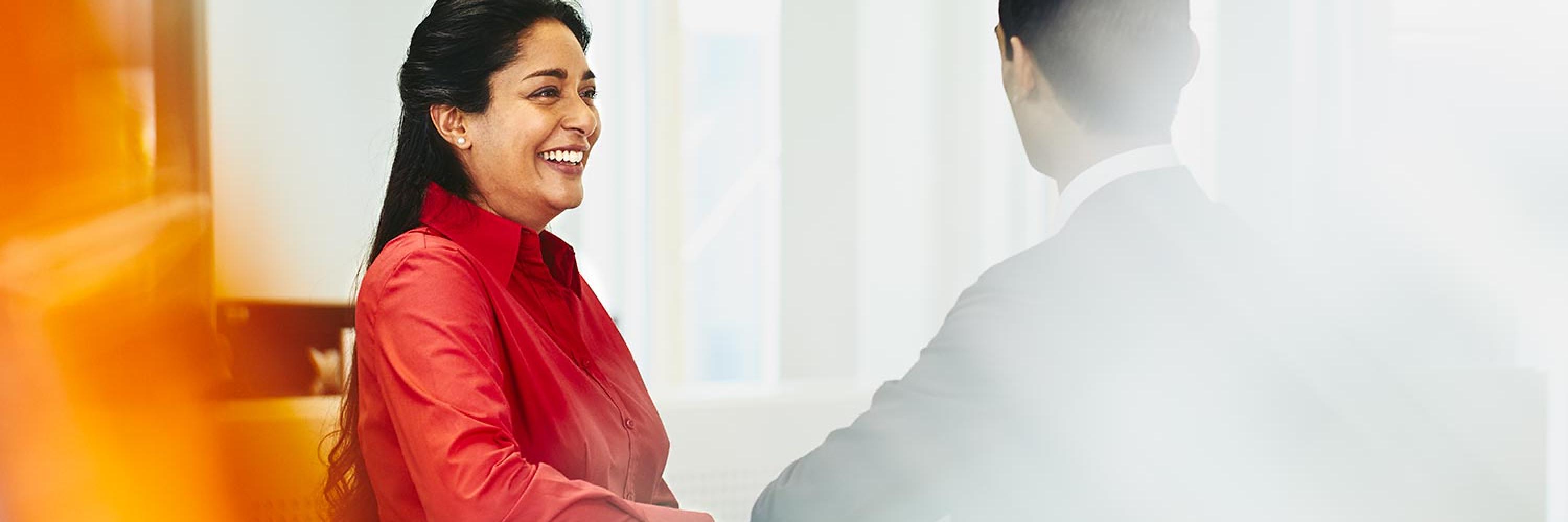 Smiling woman and man talking.