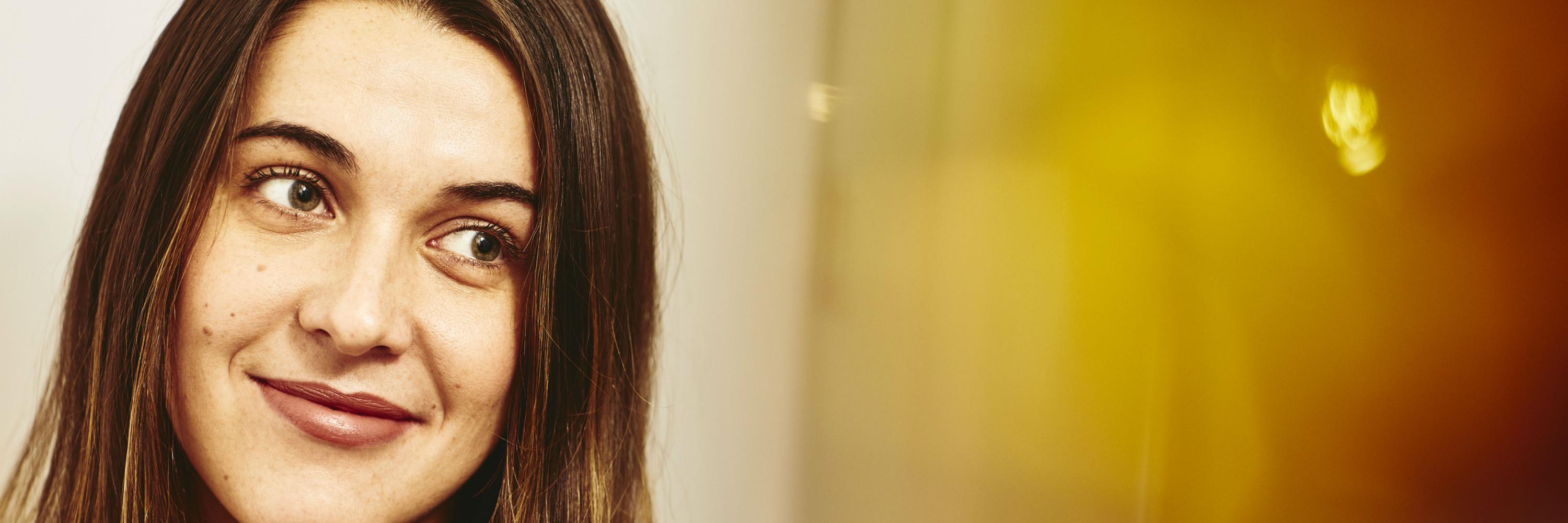 Close up - Smiling woman looking away