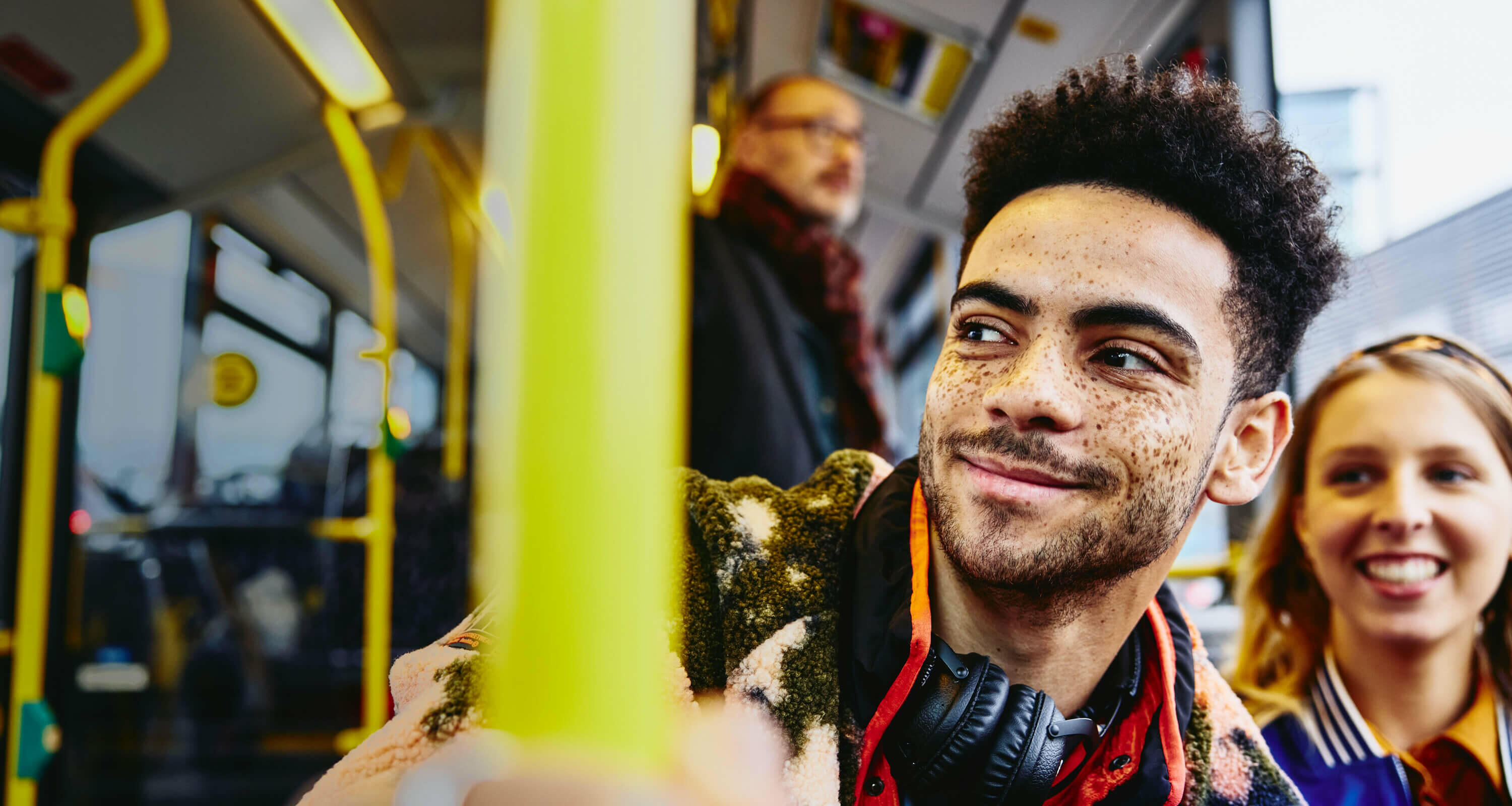 man and women in a bus, smiling
