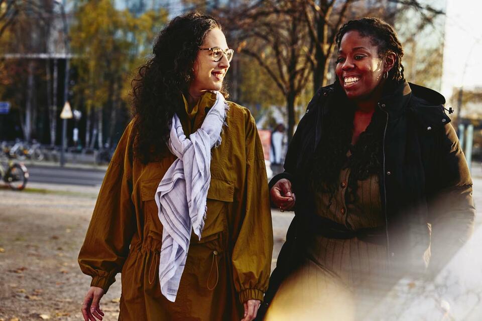 two girls talking in the park