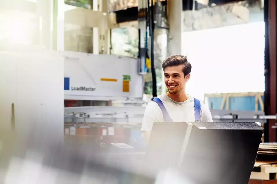 Smiling male on a production site
